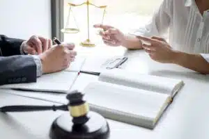 A client asking a solicitor 'Can I claim if I've been injured by a broken ladder at work?'.