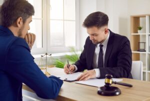 A solicitor with a client working on their swimming pool accident claim.