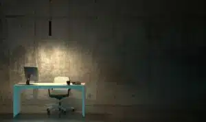 Poor lighting in a room with a desk and chair.