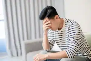 A man suffering from anxiety, waiting to make a psychological injury claim.