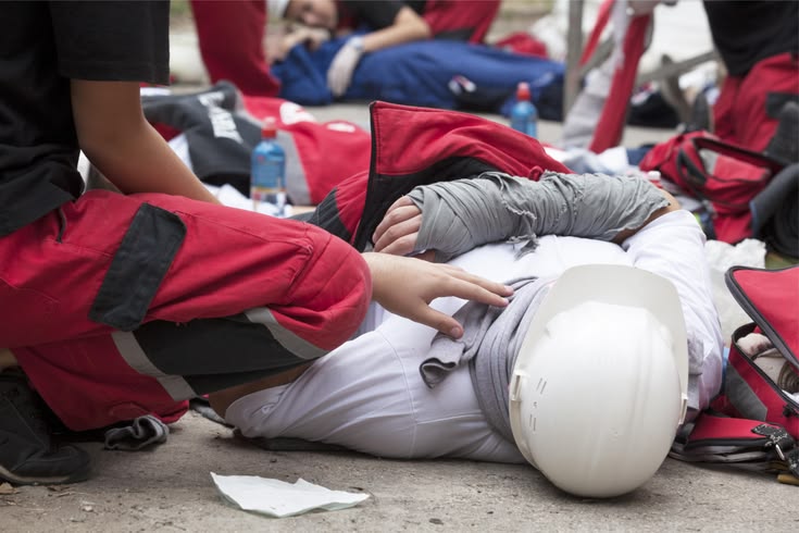 a man lying on the ground after suffering a personal injury at work